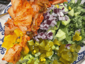 Rainbow Salad with Red Onions, Cucumber, Spinach, Romaine Lettuce, and Vegan Kimchi